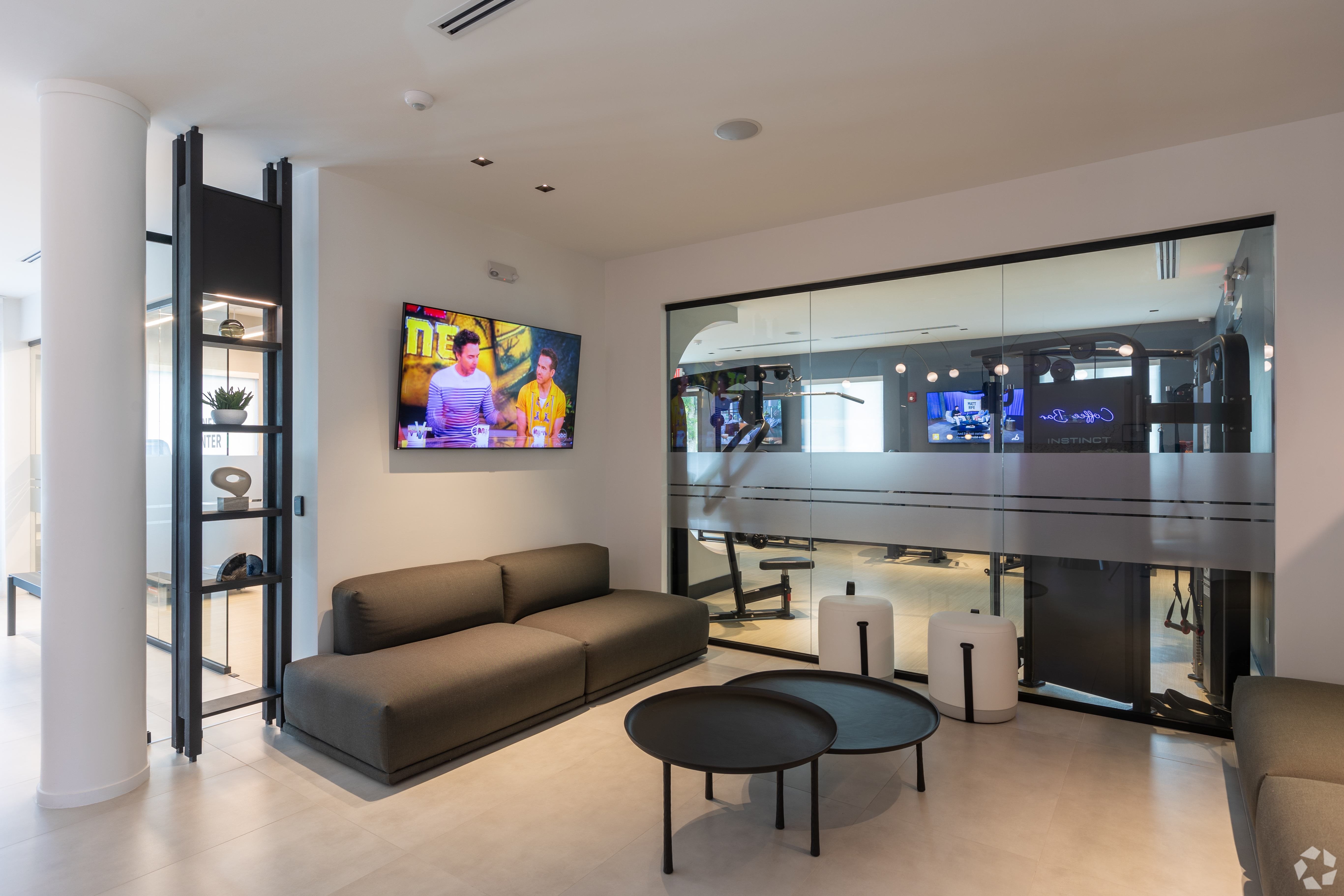 A modern living room with a grey sofa and a television.
